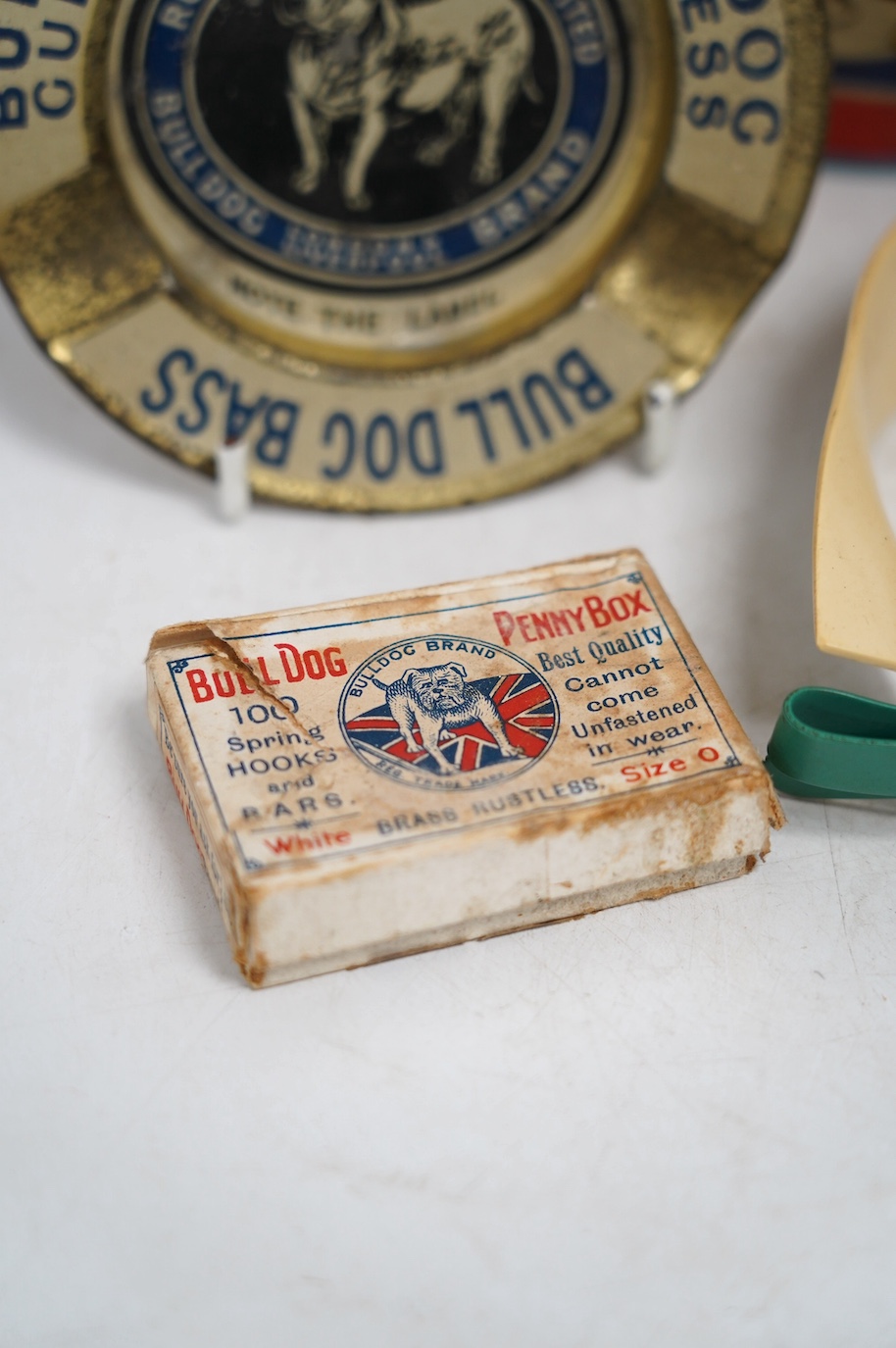 A vintage Bull Dog Bass and Guinness tinplate advertising ashtray, two Happynak Mickey Mouse toy buckets, a bakelite dog collar, etc. (5). Condition - fair